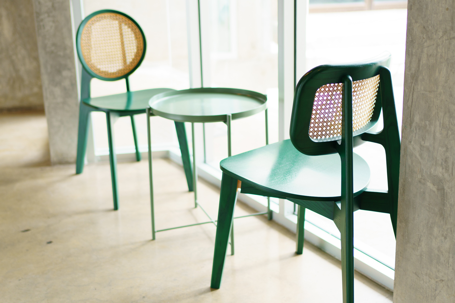 Room corner with a metal green table and chairs